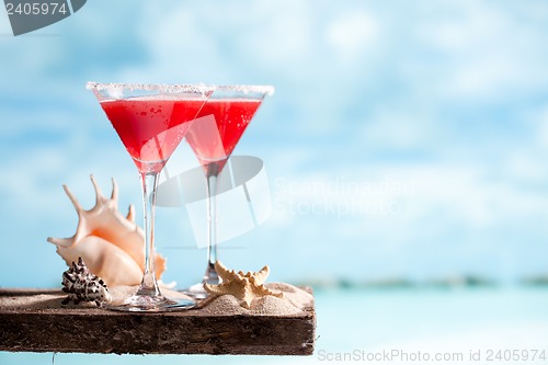 Image of red drink on beach