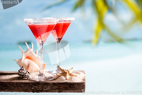 Image of red drink on beach