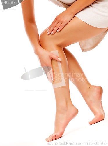 Image of woman doing depilation