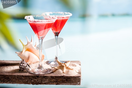 Image of red drink on beach