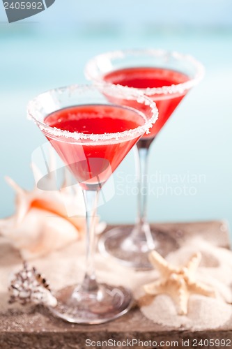 Image of red drink on beach