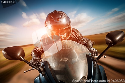 Image of Biker racing on the road