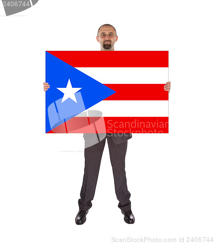 Image of Smiling businessman holding a big card, flag of Puerto Rico