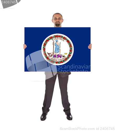 Image of Smiling businessman holding a big card, flag of Virginia