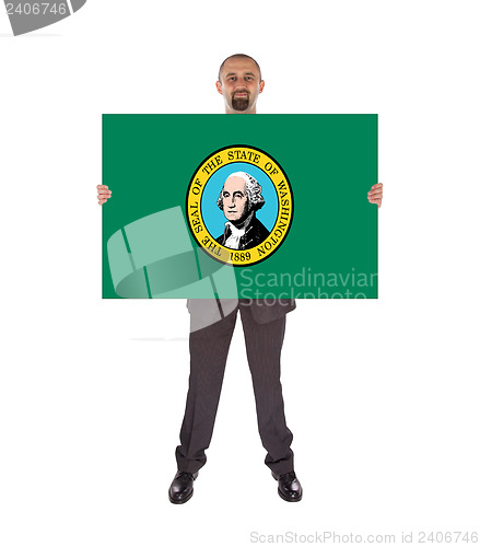 Image of Smiling businessman holding a big card, flag of Washington