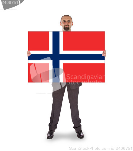 Image of Smiling businessman holding a big card, flag of Norway