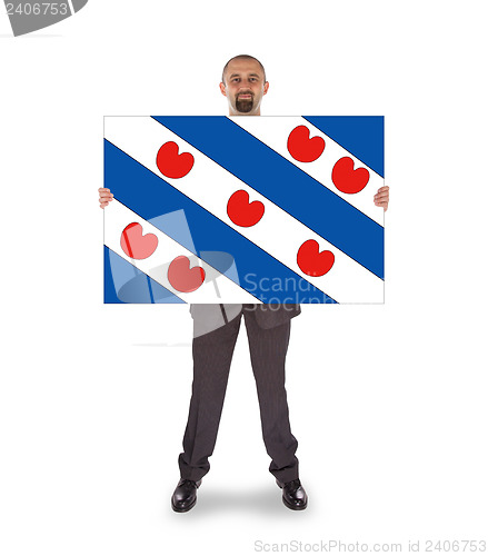 Image of Smiling businessman holding a big card, flag of the dutch provin