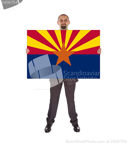 Image of Smiling businessman holding a big card, flag of Arizona