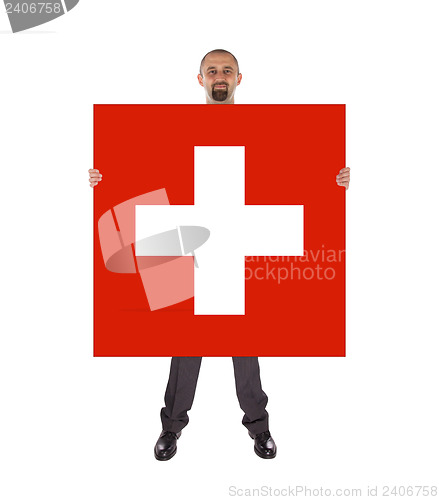 Image of Smiling businessman holding a big card, flag of Switzerland