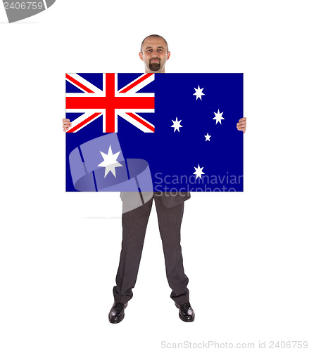 Image of Smiling businessman holding a big card, flag of Australia