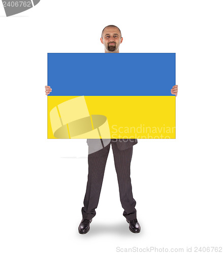 Image of Smiling businessman holding a big card, flag of Ukraine