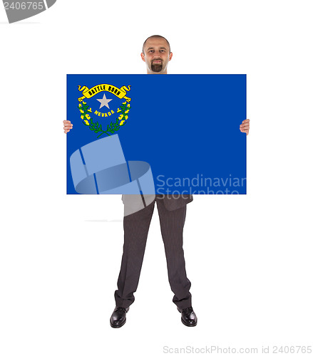 Image of Smiling businessman holding a big card, flag of Nevada