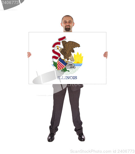 Image of Smiling businessman holding a big card, flag of Illinois