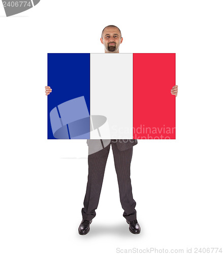 Image of Smiling businessman holding a big card, flag of France
