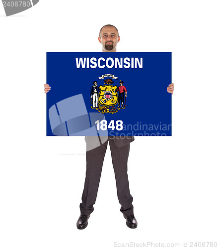 Image of Smiling businessman holding a big card, flag of Wisconsin