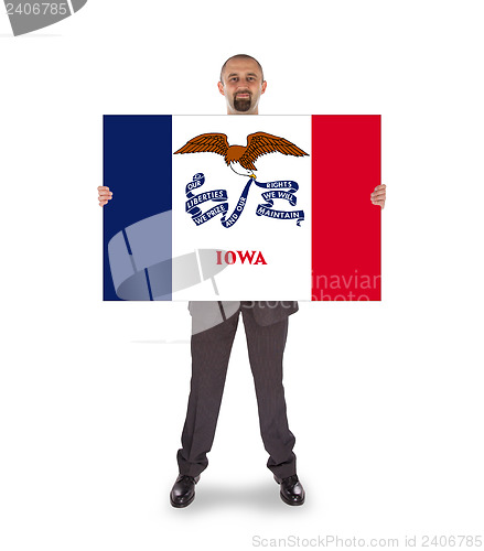Image of Smiling businessman holding a big card, flag of Iowa