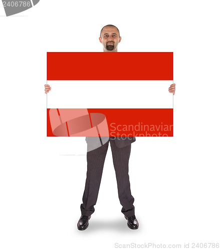 Image of Smiling businessman holding a big card, flag of Austria