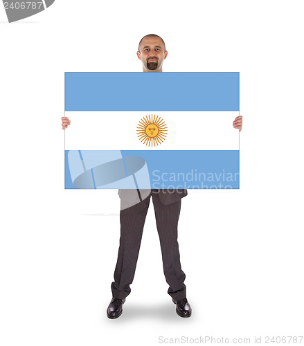 Image of Smiling businessman holding a big card, flag of Argentine