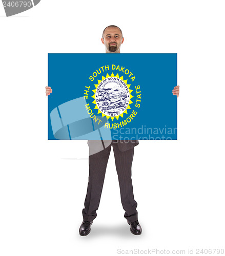 Image of Smiling businessman holding a big card, flag of South Dakota