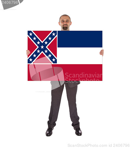 Image of Smiling businessman holding a big card, flag of Mississippi