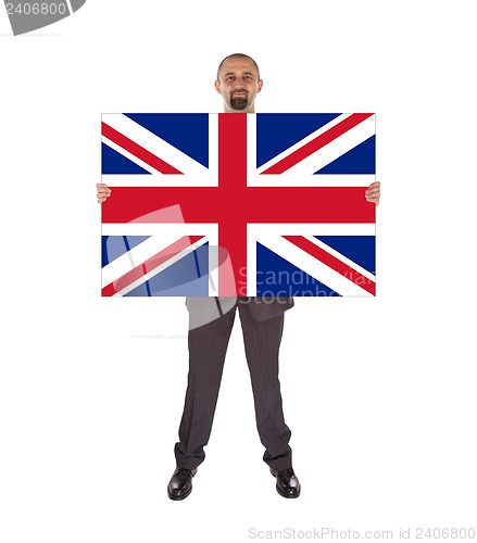 Image of Smiling businessman holding a big card, flag of the United Kingd