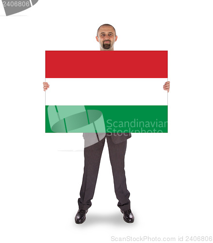 Image of Smiling businessman holding a big card, flag of Hungary
