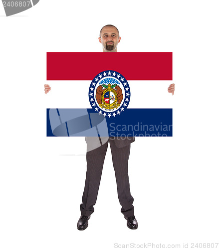 Image of Smiling businessman holding a big card, flag of Missouri