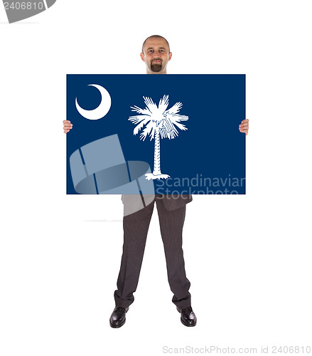 Image of Smiling businessman holding a big card, flag of South Carolina