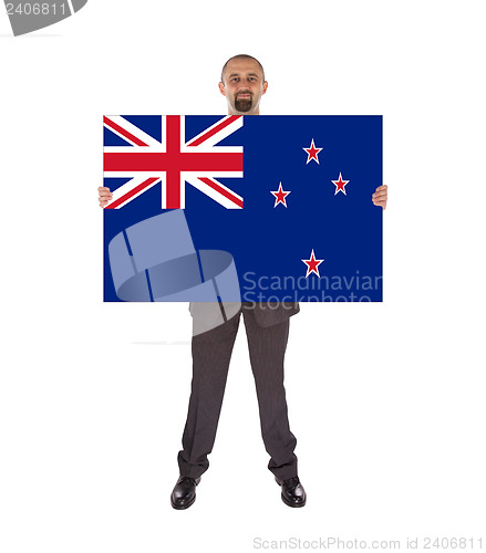 Image of Smiling businessman holding a big card, flag of New Zealand