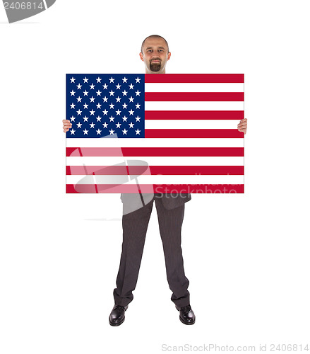 Image of Smiling businessman holding a big card, flag of the United State