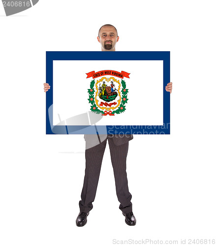 Image of Smiling businessman holding a big card, flag of West Virginia