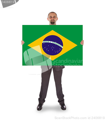 Image of Smiling businessman holding a big card, flag of Brazil