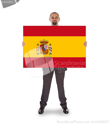 Image of Smiling businessman holding a big card, flag of Spain