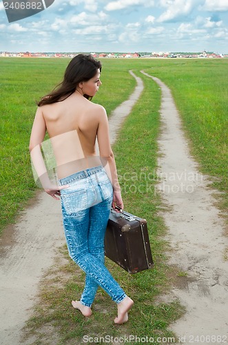 Image of Attractive topless woman with suitcase