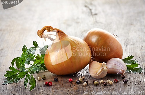 Image of onions and garlic on a wooden table