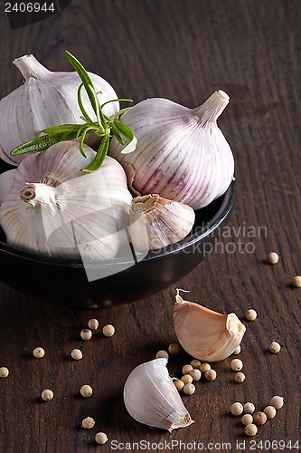 Image of Garlic and white pepper on brown wooden table
