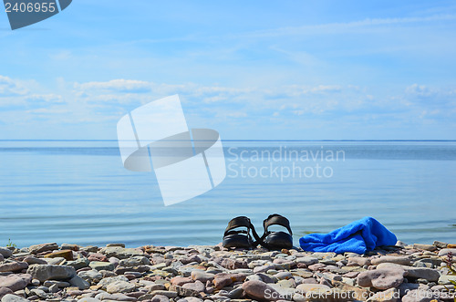 Image of Shoes and towel at coast