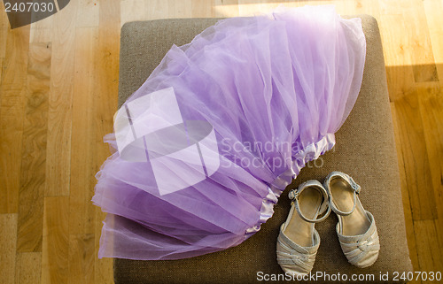 Image of girl lilac ballerina skirt light gray shiny shoes  