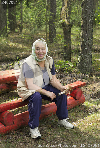Image of Elderly woman found a mushroom