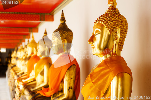 Image of Golden Buddha in a row