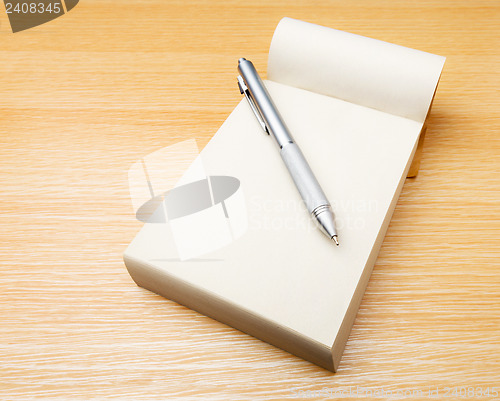 Image of Memo pad and pen on the table