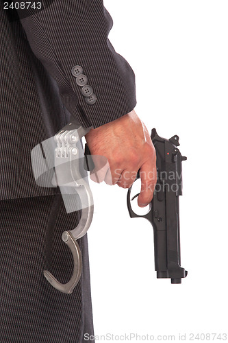 Image of Businessman with gun and handcuffs