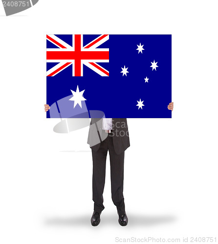 Image of Smiling businessman holding a big card, flag of Australia