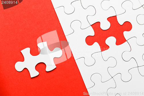 Image of Incomplete puzzle with missing piece