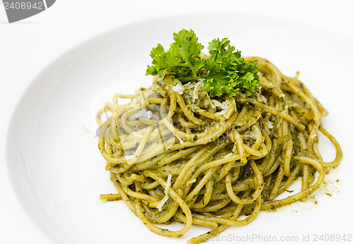 Image of Italian pasta spaghetti with pesto sauce and basil leaf 
