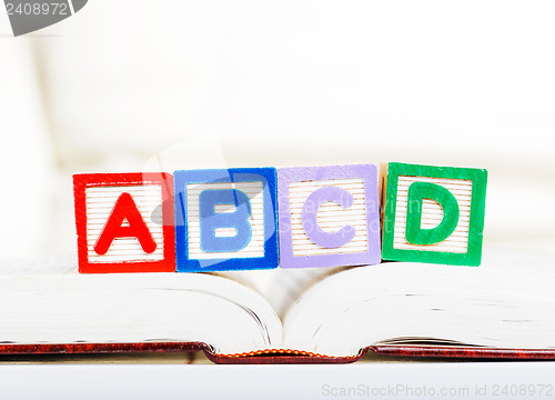 Image of Alphabet block with ABCD on book