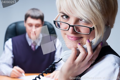 Image of businesswoman busy taking phone