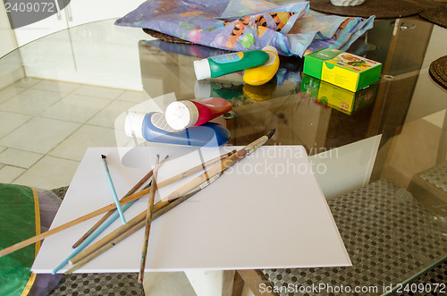 Image of table painting paper brush gouache paint tubes 