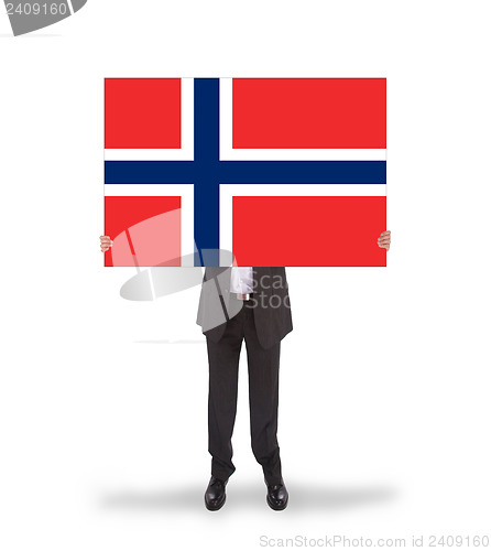 Image of Smiling businessman holding a big card, flag of Norway