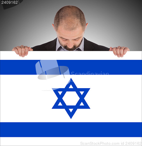 Image of Smiling businessman holding a big card, flag of Israel